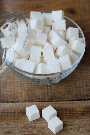 White refined sugar cubes in a glass bowlの写真素材