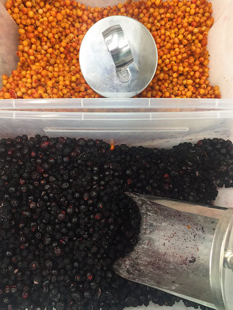 Frozen cloudberries and blueberries in the market