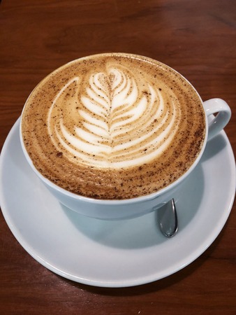 Delicious cappuccino coffee in a beautiful mugの写真素材