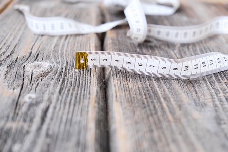 Tape for body measurements on a wooden backgroundの写真素材