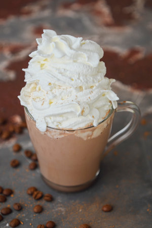 Delicious hot chocolate with whipped cream in glass cup