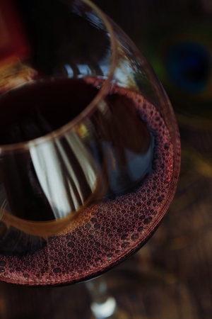 Glass of red wine on a wooden tableの写真素材