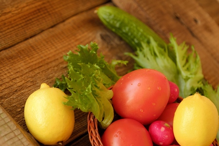 Summer vegetables and fruits on a wooden tableの写真素材