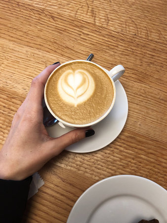 Delicious cappuccino with a pattern in the restaurant