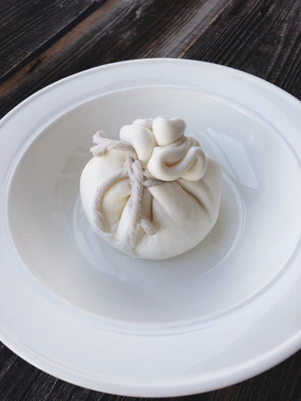 Fresh burata cheese in a white plate