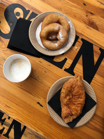 Delicious donuts with powdered sugar and coffee