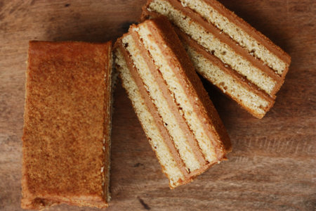 Delicious honey cake on wooden table close up