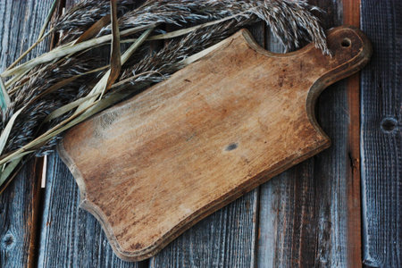 Gray wooden background and rye close up