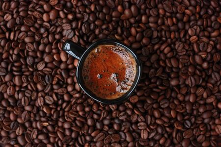 Delicious fresh coffee in a black mugの写真素材