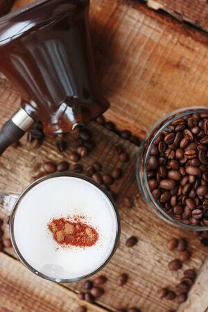 Roasted coffee beans and a cinnamon dolce latteの写真素材