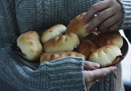 Delicious fresh pies with jam in handの写真素材