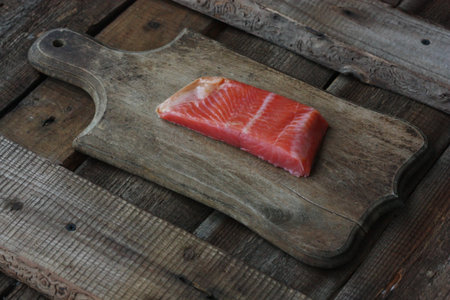 Fresh fish fillet on a wooden table