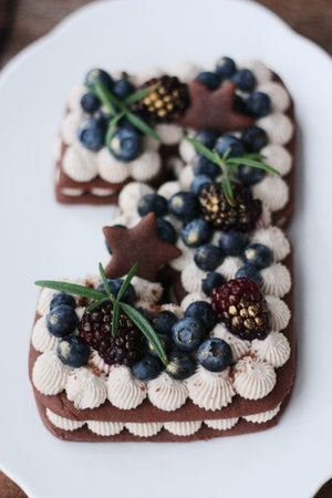 Delicious chocolate cake with cream and blueberries