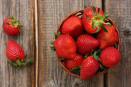 Delicious juicy strawberries on a wooden tableの写真素材