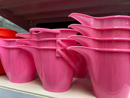 Pink plastic bucket on shelf in supermarket, closeup of photo.の写真素材