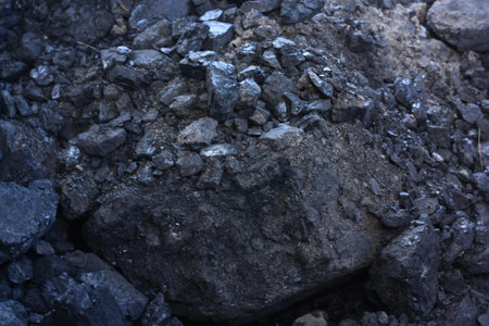 Coal on the surface of the black volcanic rock close-up