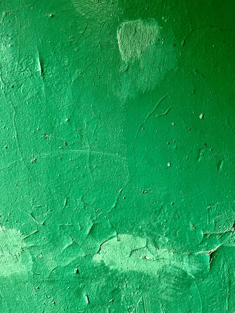 Green wall with peeling paint. Abstract background and texture for design.