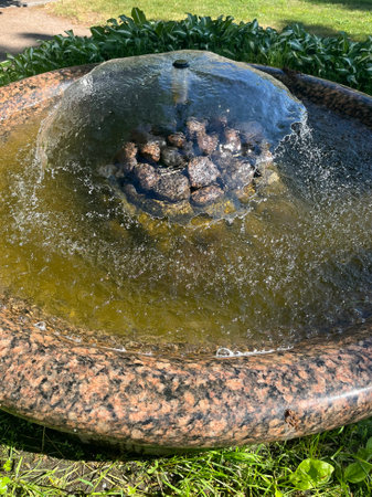 Close-up of a fountain in a city park on a sunny dayの写真素材