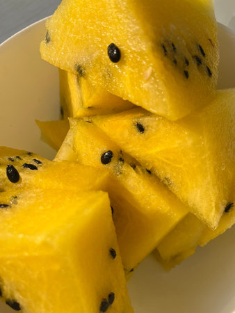 Slices of yellow fruit on a plate, close up
