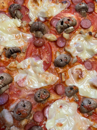 Pizza with mushrooms and cheese, close-up, top viewの写真素材