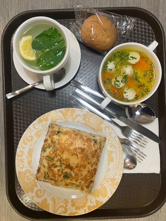 Cup of tea with omelet and lemon on the tableの写真素材