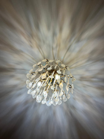 Beautiful crystal chandelier on a background of light. Selective focus.