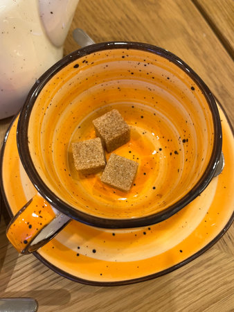 Cup of coffee with brown sugar on wooden table. Top view.の写真素材
