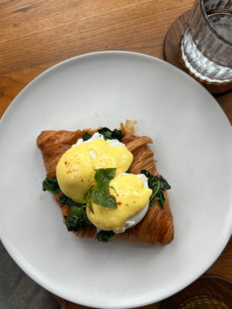Eggs benedict with hollandaise sauce and poached egg