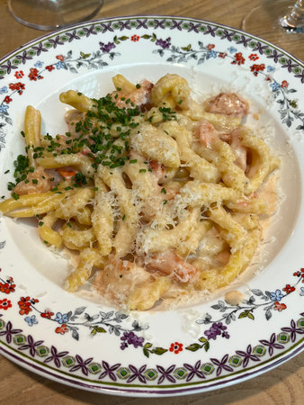 Fusilli pasta with ham and parmesan on a plate