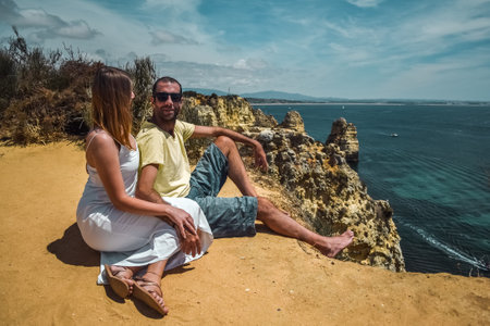 Young couple and cliffs in Lagos, Algarve, South Portugalの写真素材