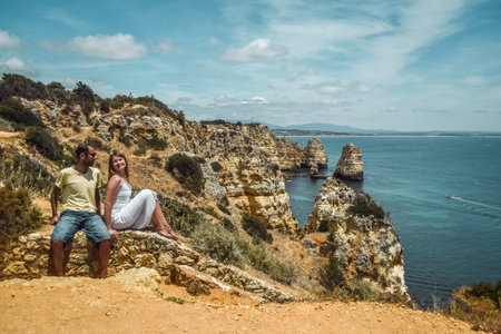 Young couple and cliffs in Lagos, Algarve, South Portugalの写真素材