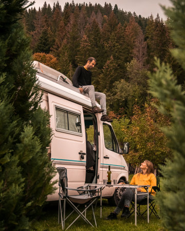 Young couple enjoying holidays in a camper van, that bring the following advantages: ease of social distancing, connection with nature and digital detox. Picture taken in Romania.の写真素材