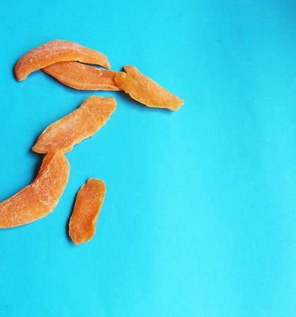 dried fruits mango orange blue bright backgroundの写真素材