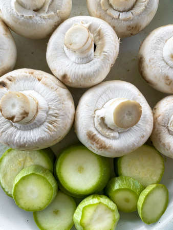 Fresh vegetables closeup. White champignons and zucchiniの写真素材
