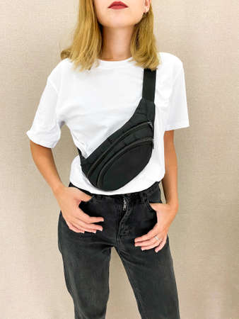 Beautiful young woman in blank white t-shirt and black jeans