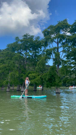 A beautiful girl on sub-board on seashore. Healthy lifestyle concept, water sports. Beautiful...