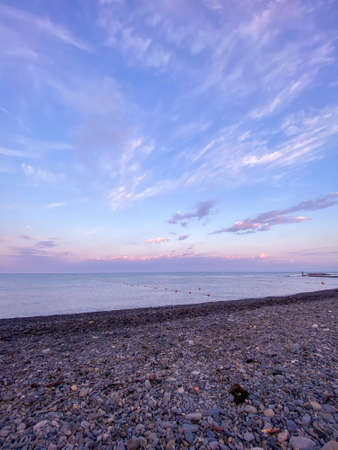 Shot of the sunset at the sea. Sunset at beach, photo vertical
