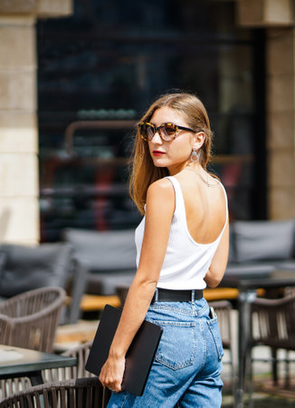 wonderful young businesswoman stands near street city cafeの写真素材