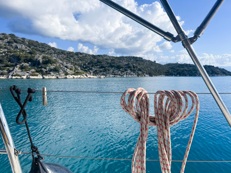 Scenic coastal view with knots and azure waters from a sailboat at midday