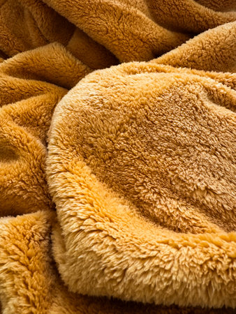 Soft, warm, and cozy textured fabric creates inviting atmosphere in a sunny roomの写真素材