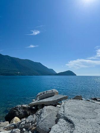 Beautiful coastal view with mountains and clear blue water in the background