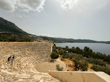 Historic amphitheater overlooking serene bay during daylight in a coastal townの写真素材