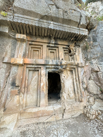 Ancient rock-cut architecture located in a secluded area with intricate carvingsの写真素材