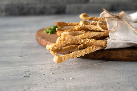 Bread sticks, italian grassini, homemade snacks with sesame seeds and whole grain flour. Close up....