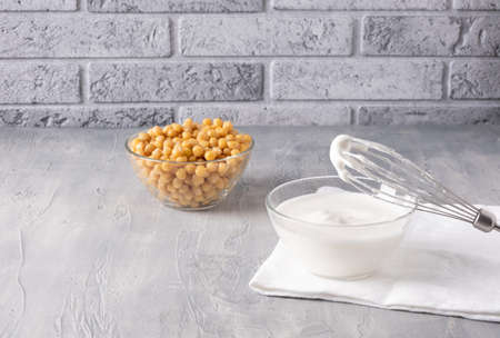 Chickpea water aquafaba whipped in a bowl. Bowl with boiled chickpeas nearby. Vegan food.の写真素材