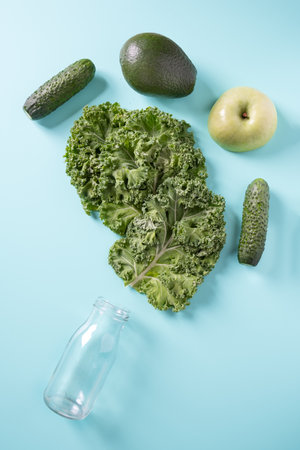 Empty battlle and green vegetables for smoothie. Top view.の写真素材