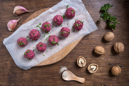 Georgian beetroot phali or pkhali with walnuts, garlic and spices on wooden background.の写真素材