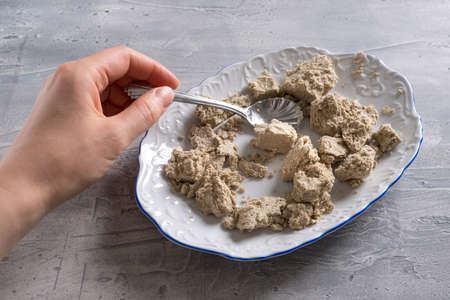 Halva or halvah on plate with spoon on the table.の写真素材