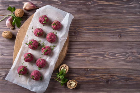 Georgian beetroot phali or pkhali with walnuts, garlic and spices on wooden background.の写真素材