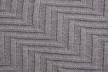 Geometric light grey knitted wool background texture